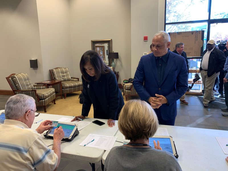 Portia Ballard Espy, left, and Mike Espy, right, checking in to vote at Highland Colony Baptist Church on Tuesday, November 27, 2018.